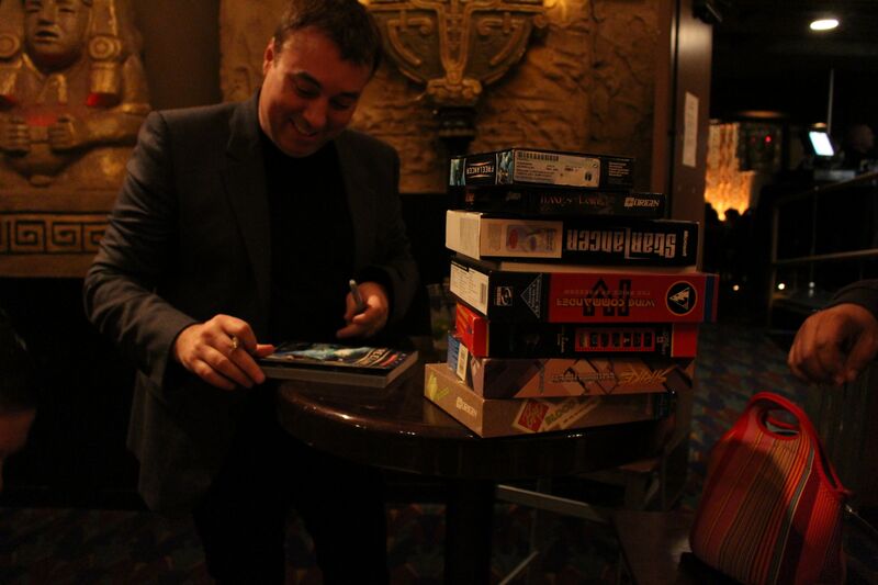 File:Chris Roberts signing some of his games for a fan.jpg